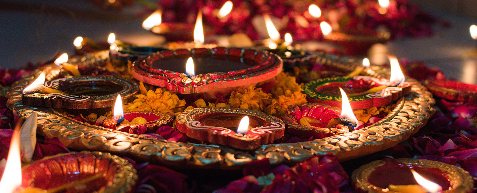 Several small candles burning in small clay pots as part of Diwali - festival of lights 