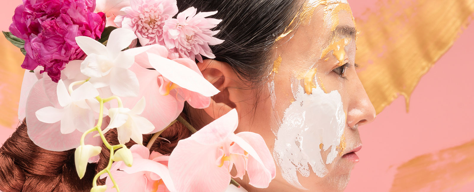 A women with flowers in her hair and paint on her face